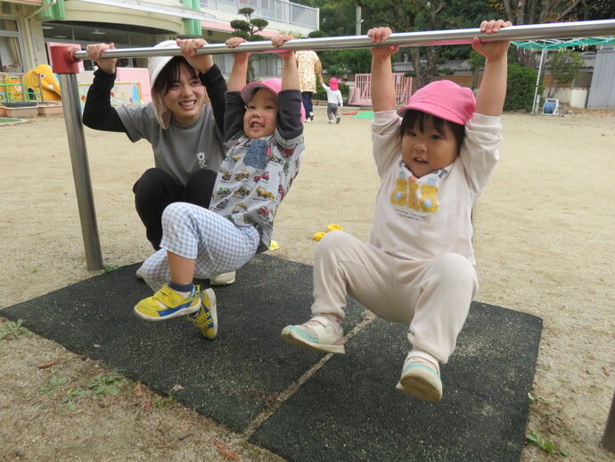 2歳児鉄棒にぶら下がっている写真