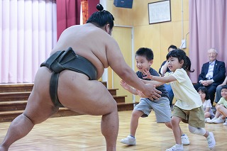 写真：年長児　お相撲さんと遊んでいる様子